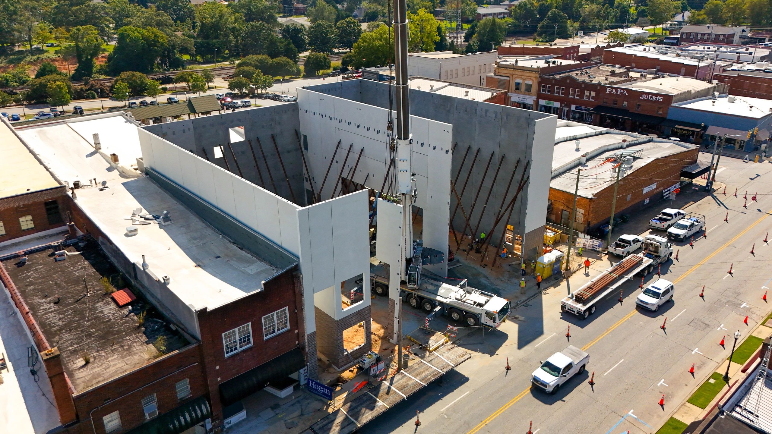 Aerial view of braced concrete walls, a crane, and delivery trucks at the Seneca Center for the Arts.