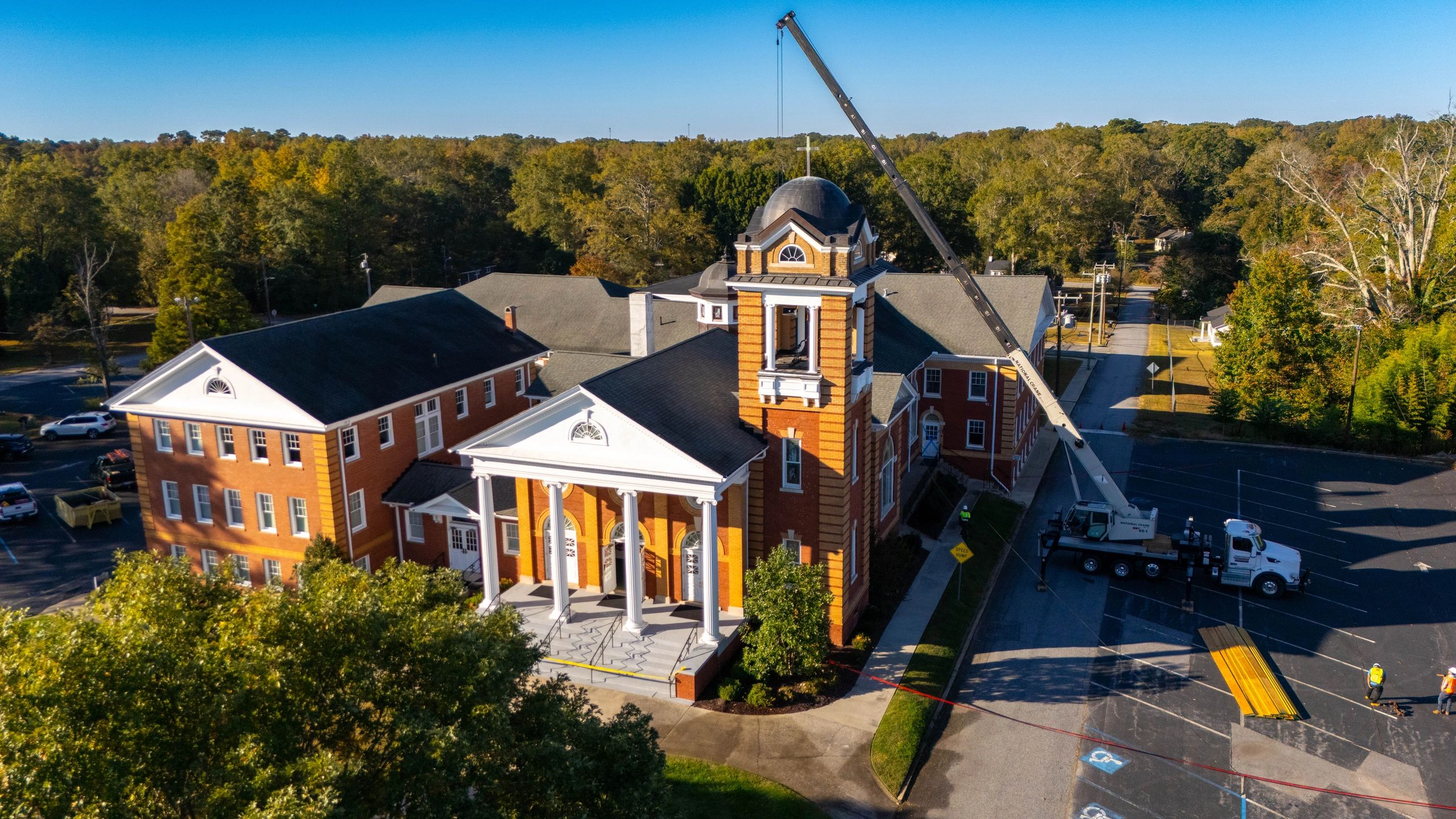 Aerial view of Belton First Baptist Church with a crane beside its bell tower.